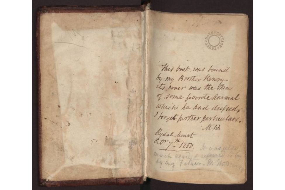 The photo shows a book with an inscription on the first page by Mary Wordsworth, which reads 'This book was bound by my Brother Henry - its cover was the skin of some favourite animal which he had dressed, I forget further particulars. MW.'